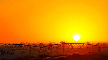 Crop watering at sunset. Oklahoma, USA