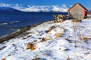 Rorbu and fjord near Sommaroy, Troms og Finnmark, north west Norway, Scandinavia, Europe