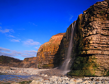 Waterfall at Cwm Bach, Traeth Bach Beach, near Southerndown, Glamorgan Heritage Coast, South Wales, United Kingdom, Europe