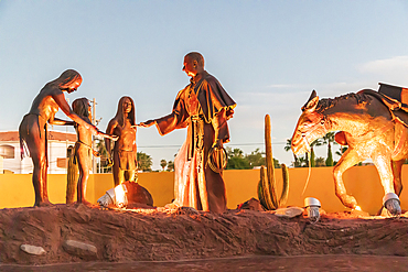 Loreto, Baja California Sur, Mexico. November 17, 2021. Sculpture of a Catholic priest interacting with indigenous Mexicans.