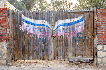 Faiyum, Egypt. February 19, 2022. Wooden gate in a wall in the village of Faiyum.