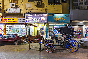 Luxor, Egypt. February 23, 2022. Horse and buggy on a street in Luxor.