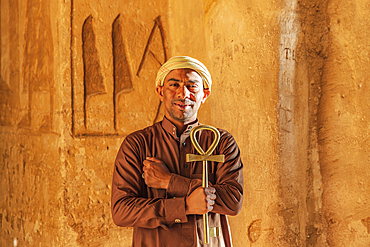 Abu Simbel, Aswan, Egypt. February 23, 2022. Caretaker holding a large key in the shape of an Ankh in the Great Temple of Ramesses II.