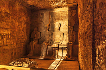 Abu Simbel, Aswan, Egypt. February 23, 2022. Sunrise light on statues of Ptah, Amun, Ramesses II, and Ra in the Holiest of Holies in the Great Temple of Ramesses II.