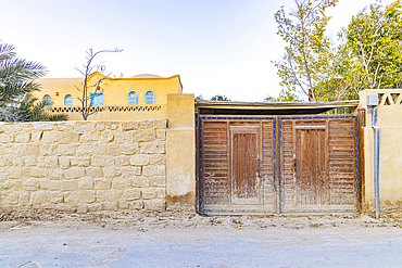 Faiyum, Egypt. Wooden gate in a wall in the village of Faiyum.