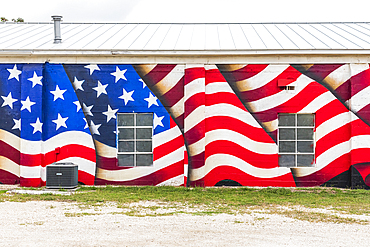 Bandera, Texas, USA. April 14, 2021. Mural of an American flag on a building in Texas.