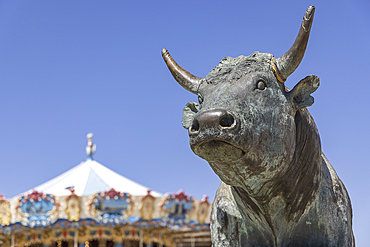 Saintes-Maries-de-la-Mer, Bouches-du-Rhone, Provence-Alpes-Cote d'Azur, France. July 3, 2022. Bronze statue of a bull leaping a fence in Saintes-Maries-de-la-Mer.