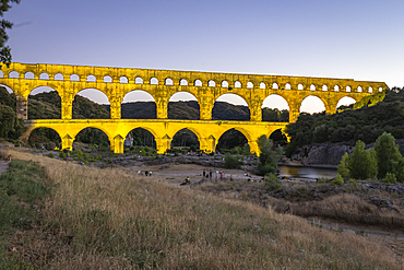 Vers-Pont-du-Gard, Gard, Occitania, France. Evening view of the illuminated Pont du Gard.