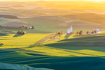 Steptoe Butte State Park, Washington, USA. May 21, 2021. Sunset view of grain silos and wheat fields in the rolling Palouse hills. Editorial Use Only