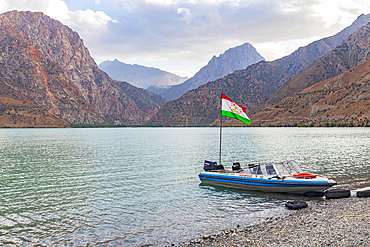 Iskanderkul, Sughd Province, Tajikistan. August 15, 2021. Boat with the Tajik flag on Iskanderkul Lake. Editorial Use Only