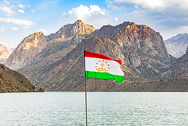 Iskanderkul, Sughd Province, Tajikistan. Tajik flag and mountain at Iskanderkul Lake.