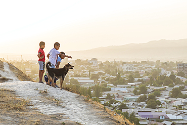 Panjakent, Sughd Province, Tajikistan. August 18, 2021. Boys and a dog looking over the city of Panjakent. Editorial Use Only