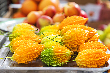 Khujand, Sughd Province, Tajikistan. Small bumpy yellow pomegranates at the Panjshanbe Bazaar in Khujand.