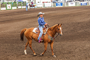 USA, Washington State, Whitman County. Palouse. Palouse Empire State Fair. Colfax. September 9, 2021. Woman on a horse at a rodeo.