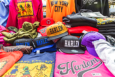 Harlem, Manhattan, New York City, New York, USA. November 4, 2021. Souvenir caps and shirts for sale in Harlem.