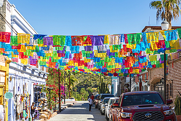 Todos Santos, Baja California Sur, Mexico. November 11, 2021. Colorful banners over a street in Todos Santos.