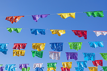 Todos Santos, Baja California Sur, Mexico. Festive colorful banners over a street in Todos Santos.