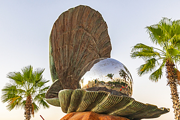 La Paz, Baja California Sur, Mexico. November 11, 2021. Sculpture of a large metal pearl in an oyster shell.