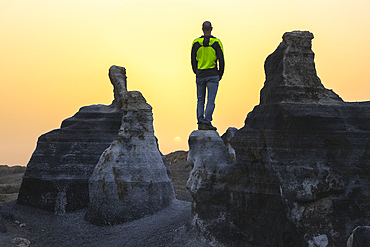 A tourist observes sunset at Stratified city in Lanzarote, Teseguite, Las Palmas, Lanzarote, Canary Islands, Spain, Atlantic, Europe