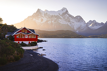 Lake Pehoe and Hosteria Pehoe with Mountains in the background during sunset, Torres del Paine NP, Ultima Esperanza, Region de Magallanes y de la Antartica Chilena, Patagonia, Chile, South America