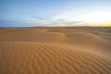 Spring sunset at the gates of the Sahara desert, with the sand dunes illuminated by the golden light, Tunisia, North Africa, Africa