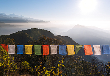 Colorful prayer flags in front of a vast mountain landscape at the foot of the Annapurna Circuit in the Himalayas, Australian Camp, Nepal, Asia