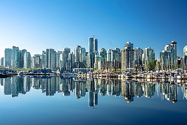 Skyline of Vancouver, with perfect reflection of skyscrapers in the blue waters of Stanley Park, Vancouver, British Columbia, Canada, North America