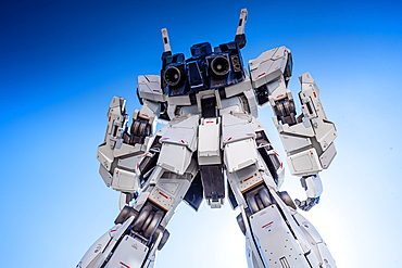 The massive Unicorn Gundam statue standing tall under a bright blue sky in DiverCity Tokyo Plaza, Odaiba.