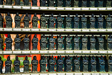 Close-up of small, blue Buddha statues neatly arranged on shelves, symbolizing serenity and devotion at Sanzen-in Temple, Kyoto.