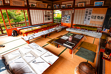 Tatami room in a Kyoto temple, featuring scrolls, ink drawings, and traditional decor, offering a glimpse into Japanese culture. Daihikaku Senkōji Temple