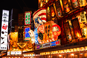 A vibrant, illuminated Japanese signboard featuring traditional japanese paintings and cultural remarks Shinsekai, Osaka, Kansai, Japan