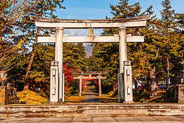 Big stone torii gate framing more distant gates on the foot of mount Iwaki. Iwakiyama-jinja Shrine Mt Iwaki Shrine in Hirosaki, Japan