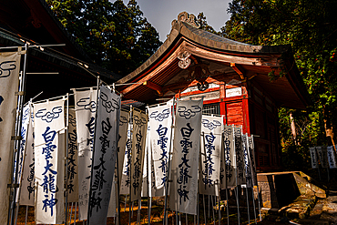 White banners with kanji written on it at The Mount Iwaki Shrine, near Hirosaki, North Honshu, Japan, Asia