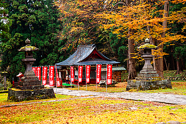 View of a Japanese temple, stone lanterns in an autumnal forest, The Mount Iwaki Shrine, near Hirosaki, North Honshu, Japan, Asia