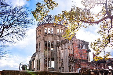 Hiroshima, Japan. Atomic Bomb Dome with lush trees in front of it