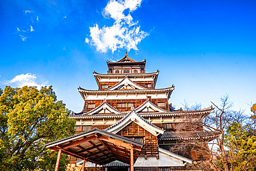 Hiroshima Castle main tower in yellow autumnal leaves. Hiroshima, Japan,