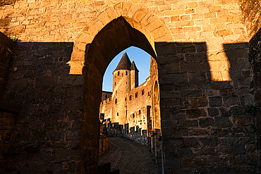 Medieval Castle Towers Framed by Archway in Carcassonne at Sunsee. La Cite, Carcassonne medieval fortified town, Aude, Languedoc-Roussillon, France, Europe