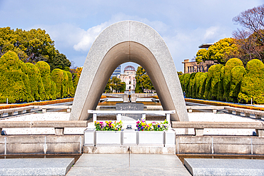 Hiroshima Peace Memorial Cenotaph in Front of the Eternal Flame Surrounded by Manicured Gardens in Hiroshima, Japan