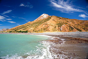 Golden Coastal Hills Meeting Calm Emerald Waters Under Blue Skies at Ward Beach, Marlborough, New Zealand