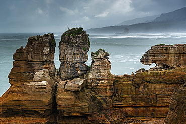 Twin Rock Formations at Pancake Rocks Against a Moody Sky in Punakaiki, Paparoa National Park, New Zealand