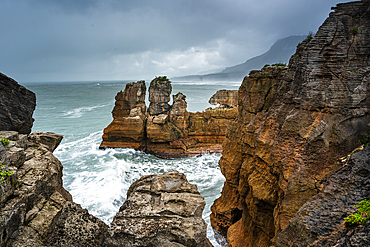 Towering Limestone Stacks of Pancake Rocks Surrounded by Crashing Waves at Punakaiki, West Coast, New Zealand