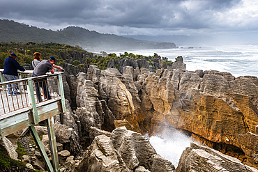 Crowd Watching Sea Spray Erupting from Blowhole at Pancake Rocks, Punakaiki, Paparoa National Park, New Zealand