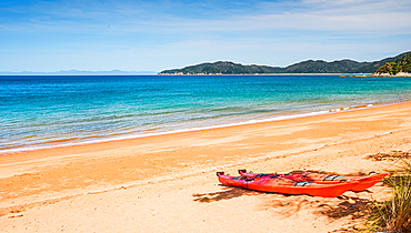 Red Sea Kayaks Resting on Orange Sand at Crystal Bay, Abel Tasman National Park, New Zealand