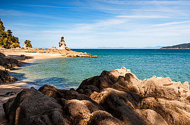 Famous Rock Tower on Rocky Shoreline Overlooking Turquoise Sea at Abel Tasman National Park, New Zealand
