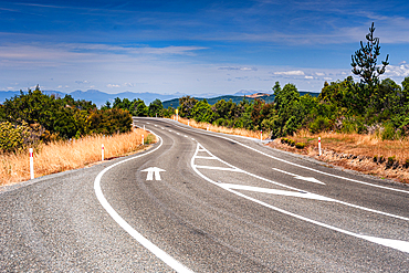 Sweeping Bend on Mountain Road Overlooking Valley and Peaks, South Island Landscape, New Zealand