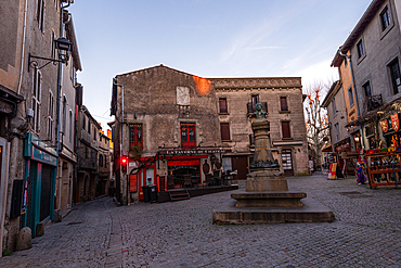 Evening scene at Place Carnot in La Bastide Saint-Louis, Carcassonne, surrounded by cafés and shops