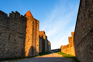 Rich Golden Light Highlighting the Texture of the Stone Walls and Battlements in the Fortified City of Carcassonne