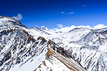 Snowy Ridge Trail Leading South Toward Ganja La Pass with Far Distant View of the Rolwaling Himalaya from Kyanjin Ri