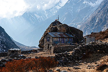 Blue-windowed stone house at remote hillside location in the dramatic Langtang Valley, Nepal