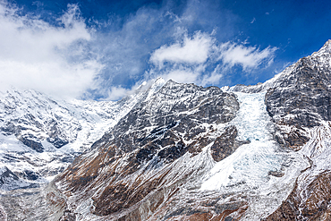Massive glacier flowing down from Langtang Lirung under dramatic skies, viewed from high ridge in Langtang National Park, Nepal
